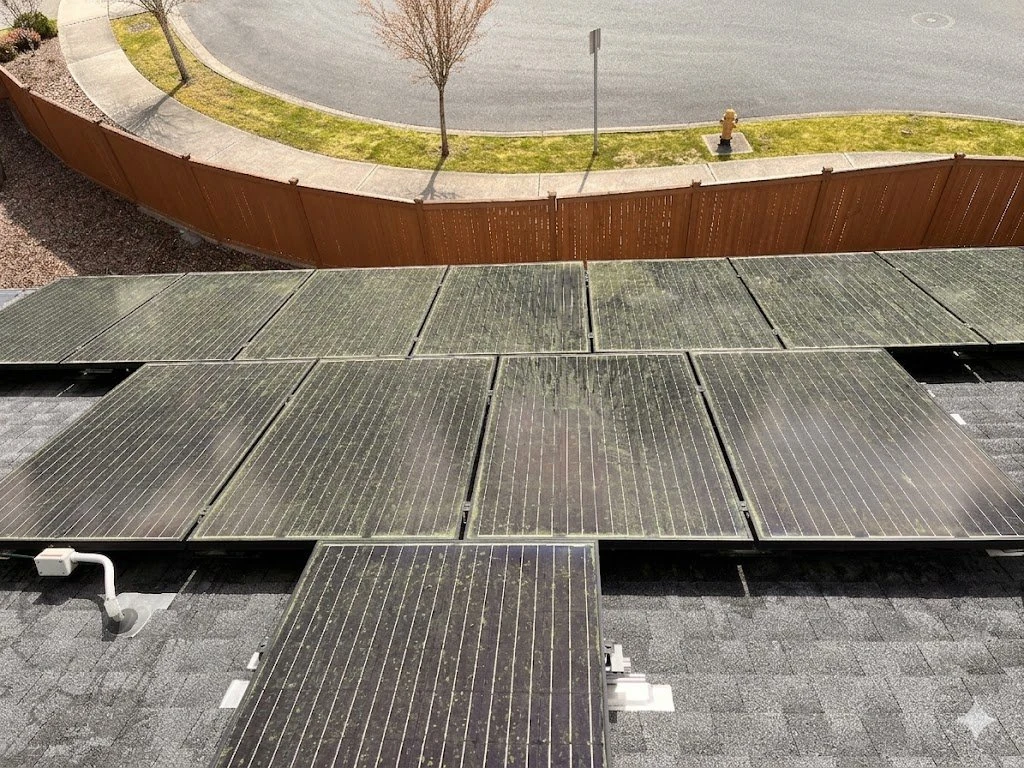 Wide view of dirty solar array with visible streaks and grime reducing output